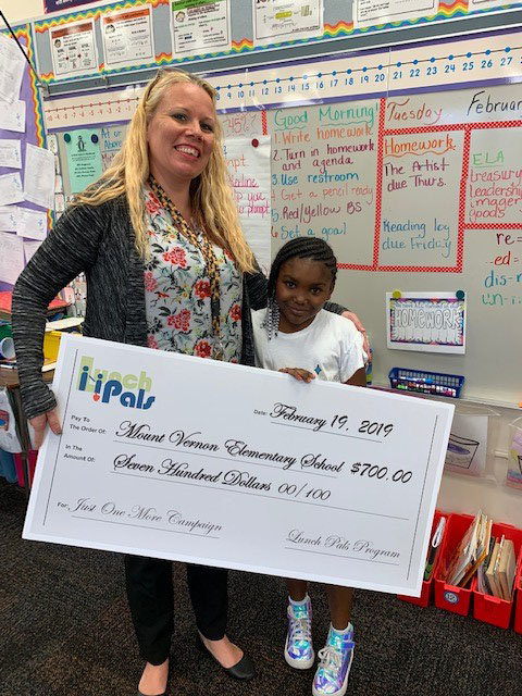 Student with Mount Vernon Elementary student and Lunch Pals check. 